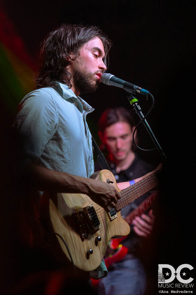 Alex singing on stage with a view from the crowd