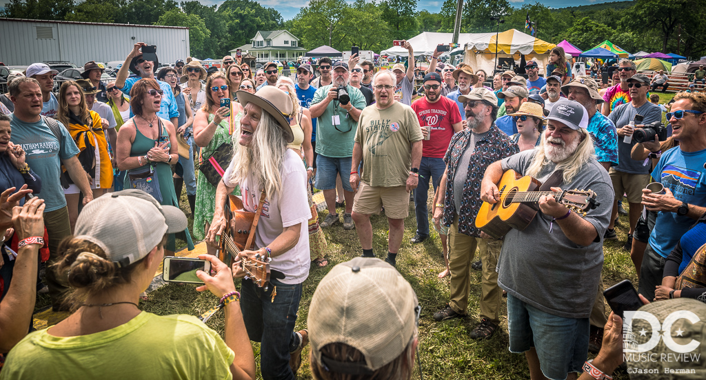 Steve Poltz and Vince Herman sing "This Land Is Your Land" by Woody Guthrie in the crowd.