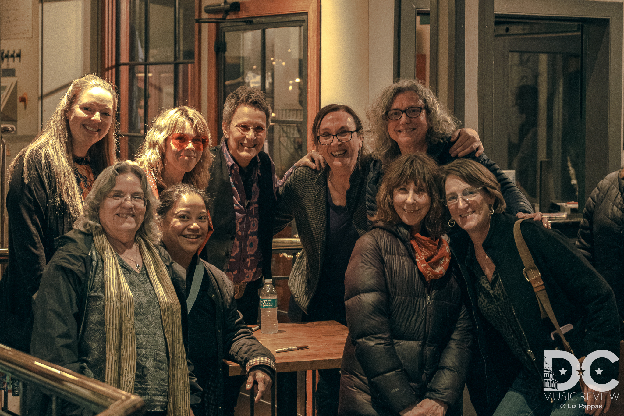 The women behind the first Mary Gauthier Tribute Show (L to R) Eryn Michel, Debbie St. Charles, Jillian Matundan, Susan Rowe, Lynn Hollyfield, Annette Wasilik, and Michelle Swan with Jamie Harris (L) and Mary Gauthier (R).